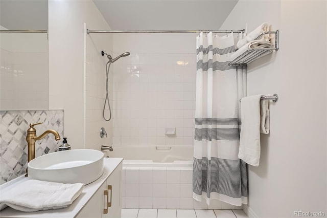 bathroom featuring tile patterned flooring, backsplash, shower / bath combo with shower curtain, and sink