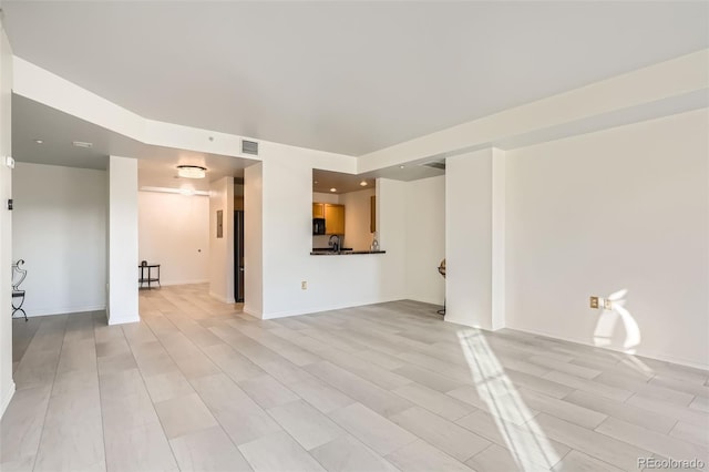 unfurnished living room with light wood-type flooring