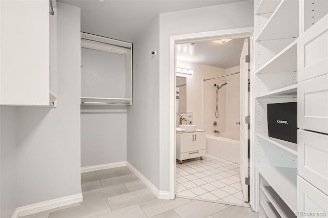 spacious closet with light tile patterned floors