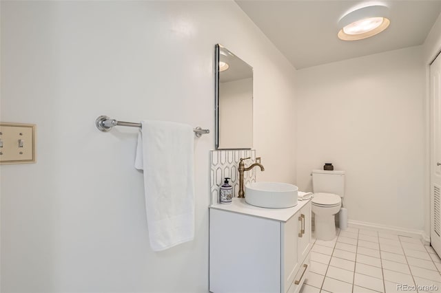 300 W 11th Ave Unit 4F, Denver, CO 80204 - half bathroom with tile patterned floors, vanity, toilet, and baseboards