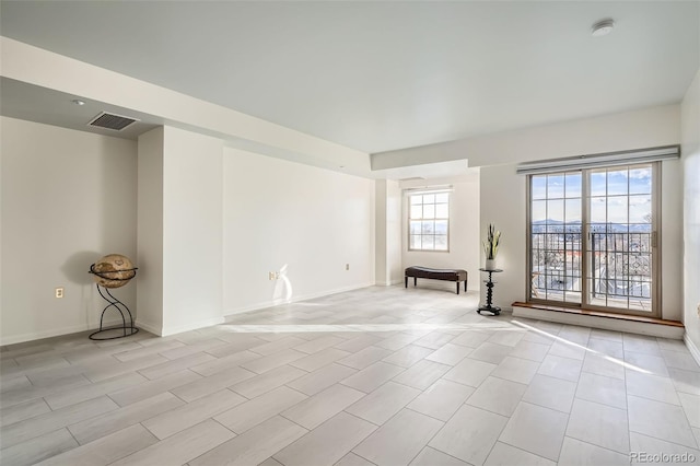 300 W 11th Ave Unit 4F, Denver, CO 80204 - empty room with a smoke detector, baseboards, and light tile patterned floors