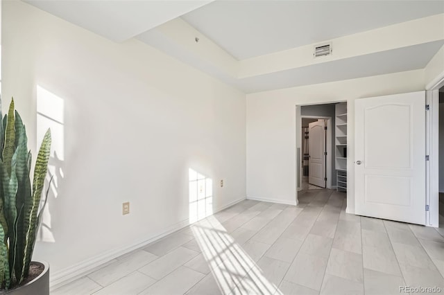 300 W 11th Ave Unit 4F, Denver, CO 80204 - unfurnished bedroom with a walk in closet and baseboards