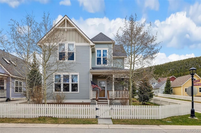 45 Bridge St, Breckenridge, CO 80424 - view of front of house with covered porch, a gate, board and batten siding, and a fenced front yard