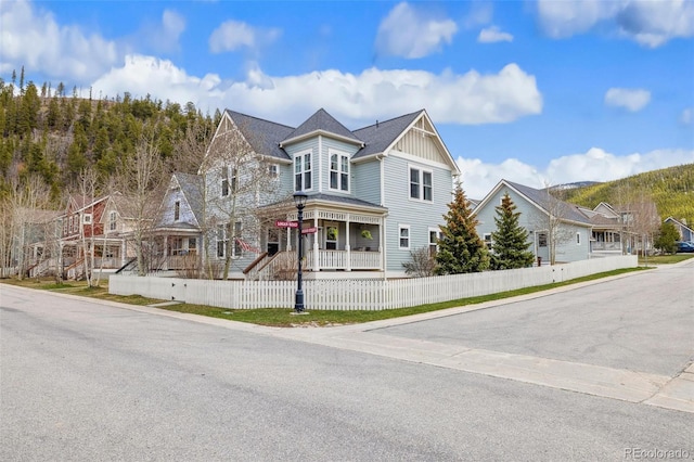 45 Bridge St, Breckenridge, CO 80424 - view of front of house with covered porch, a fenced front yard, and board and batten siding