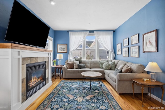45 Bridge St, Breckenridge, CO 80424 - living room with light wood-style floors, a fireplace, and baseboards