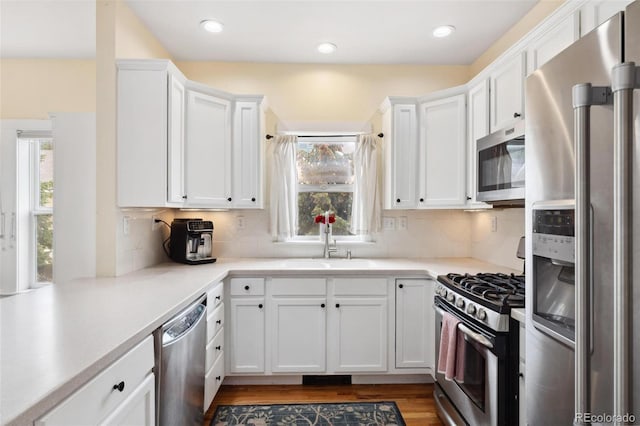 45 Bridge St, Breckenridge, CO 80424 - kitchen featuring stainless steel appliances, a sink, white cabinetry, light countertops, and recessed lighting