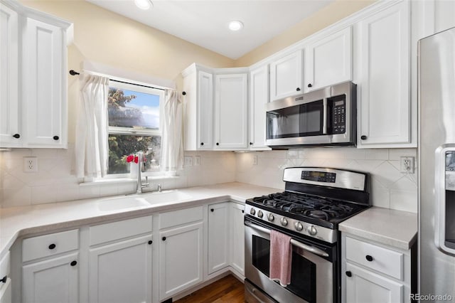 45 Bridge St, Breckenridge, CO 80424 - kitchen with stainless steel appliances, a sink, white cabinetry, light countertops, and decorative backsplash