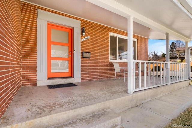 entrance to property featuring brick siding