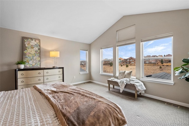 carpeted bedroom featuring lofted ceiling, visible vents, and baseboards