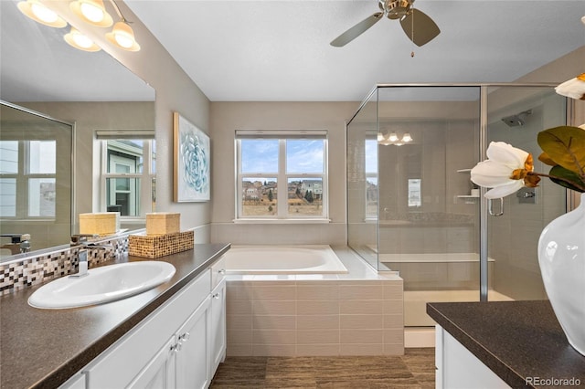 bathroom with vanity, a garden tub, a stall shower, and ceiling fan