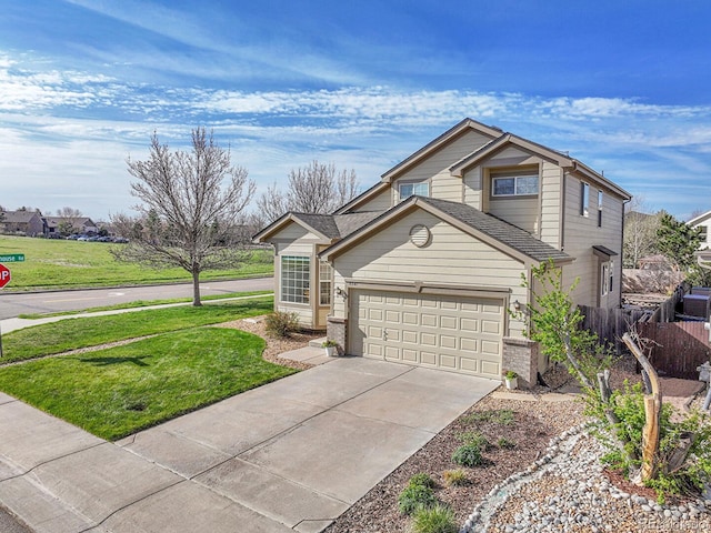 traditional-style home with a front yard, fence, an attached garage, and driveway