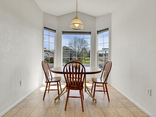 dining area with a textured wall and baseboards