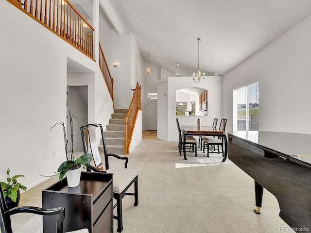 dining area with a chandelier, high vaulted ceiling, arched walkways, stairway, and light colored carpet