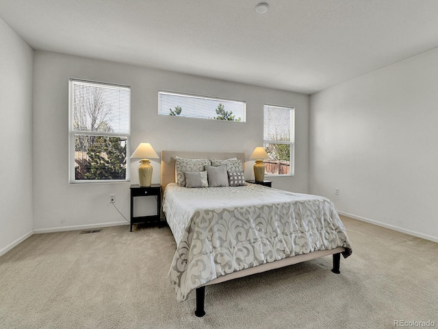 carpeted bedroom with baseboards and visible vents