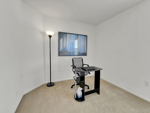 unfurnished office featuring baseboards and carpet