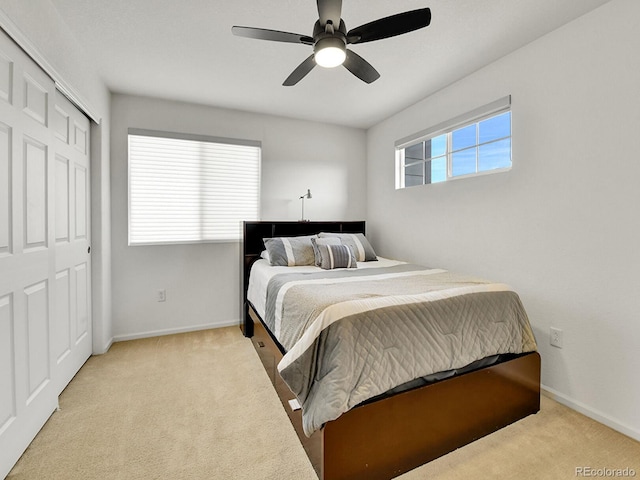 carpeted bedroom featuring baseboards, a closet, and a ceiling fan