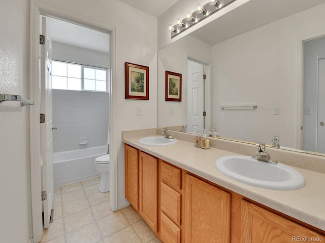 bathroom with a sink, tile patterned flooring, toilet, and double vanity
