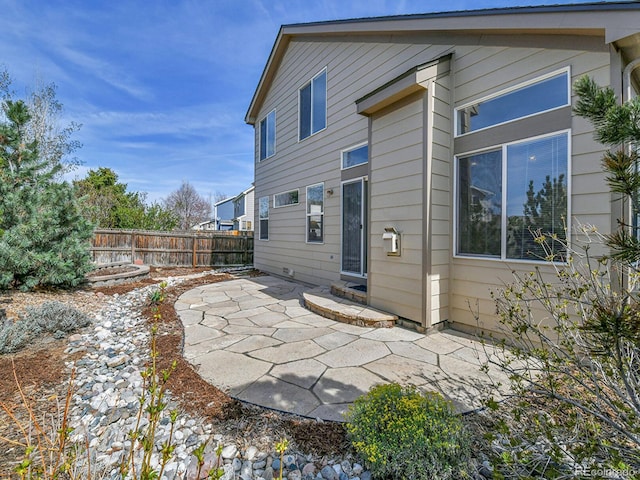 rear view of house featuring a patio and fence