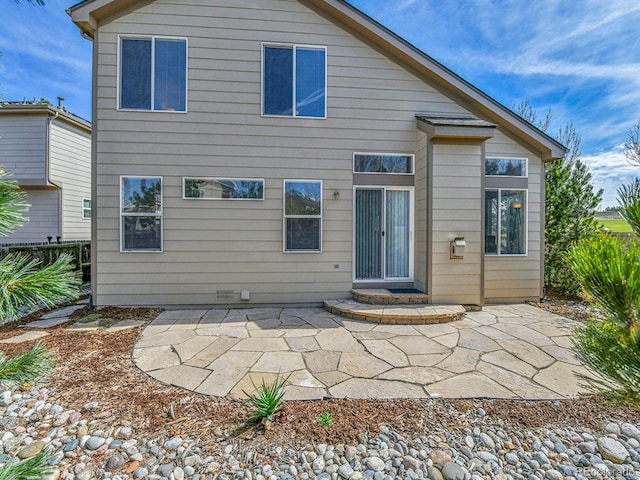 rear view of house with a patio area and fence