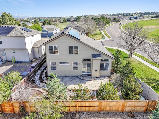 rear view of property with a patio area, a residential view, and a fenced backyard
