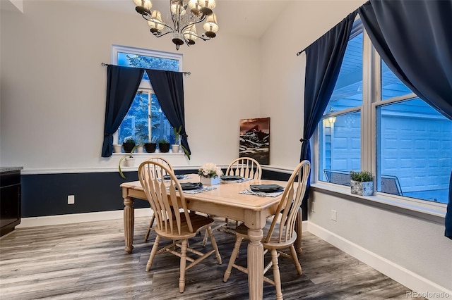 8370 Midsummer Ln, Elizabeth, CO 80107 - dining area featuring a chandelier, plenty of natural light, and wood finished floors