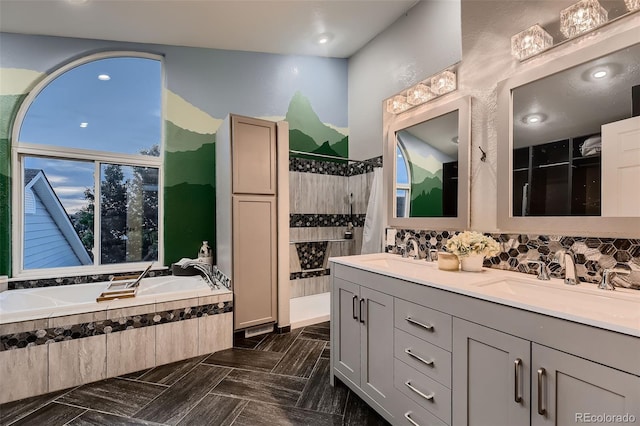 8370 Midsummer Ln, Elizabeth, CO 80107 - bathroom featuring tiled shower, a garden tub, double vanity, and decorative backsplash