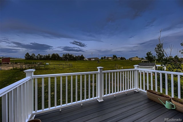 8370 Midsummer Ln, Elizabeth, CO 80107 - wooden deck featuring a lawn, an outbuilding, and a rural view