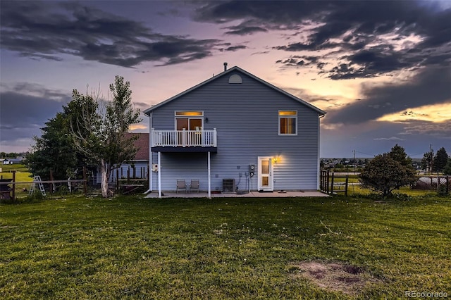 8370 Midsummer Ln, Elizabeth, CO 80107 - rear view of property with a patio, a fenced backyard, and a balcony