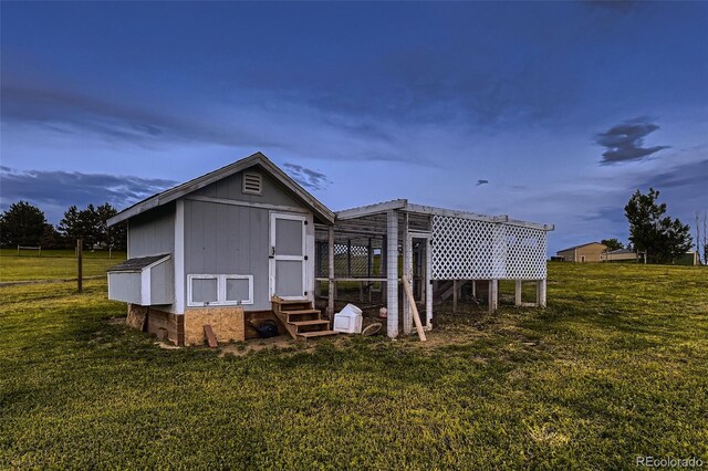 8370 Midsummer Ln, Elizabeth, CO 80107 - rear view of property featuring a yard, entry steps, exterior structure, an outdoor structure, and board and batten siding