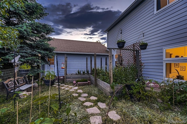 8370 Midsummer Ln, Elizabeth, CO 80107 - yard at dusk featuring a vegetable garden