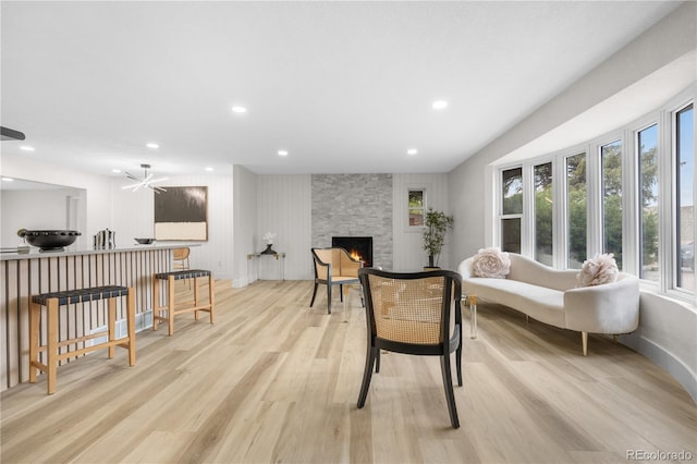 sitting room featuring light wood-type flooring, healthy amount of natural light, a fireplace, and recessed lighting
