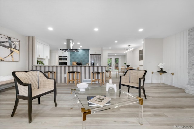 living room with light wood-type flooring, french doors, and recessed lighting