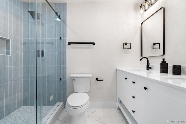 full bathroom featuring marble finish floors, a shower stall, toilet, and double vanity