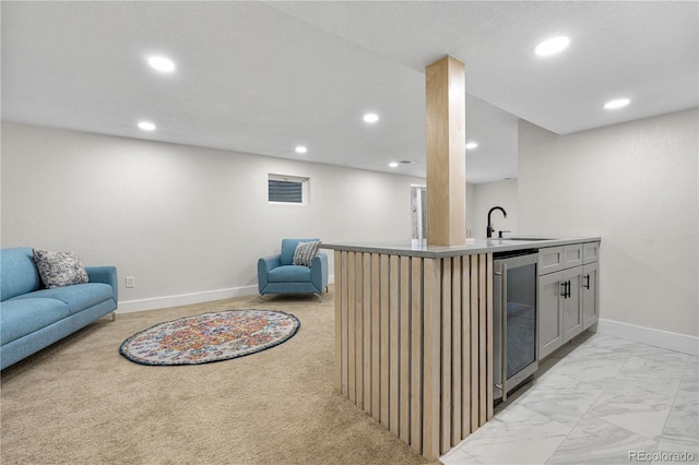 indoor wet bar featuring beverage cooler, recessed lighting, baseboards, and light marble finish flooring