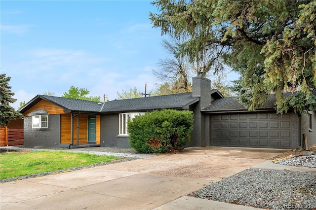mid-century home with brick siding, concrete driveway, an attached garage, a chimney, and a shingled roof