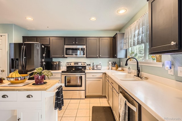 676 Hedgerow Way, Brighton, CO 80601 - kitchen featuring appliances with stainless steel finishes, light tile patterned floors, recessed lighting, and butcher block counters