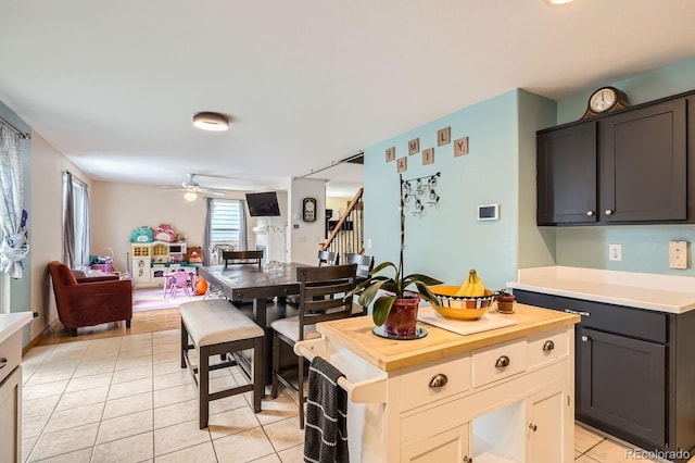 676 Hedgerow Way, Brighton, CO 80601 - kitchen featuring light tile patterned floors, open floor plan, ceiling fan, and wood counters