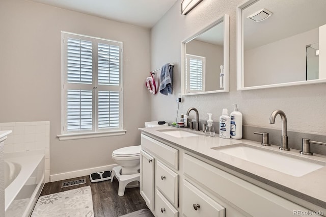 676 Hedgerow Way, Brighton, CO 80601 - full bathroom with plenty of natural light, wood finished floors, a bath, and double vanity