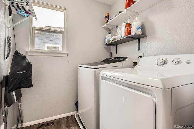 676 Hedgerow Way, Brighton, CO 80601 - laundry area with washer and clothes dryer and wood finished floors