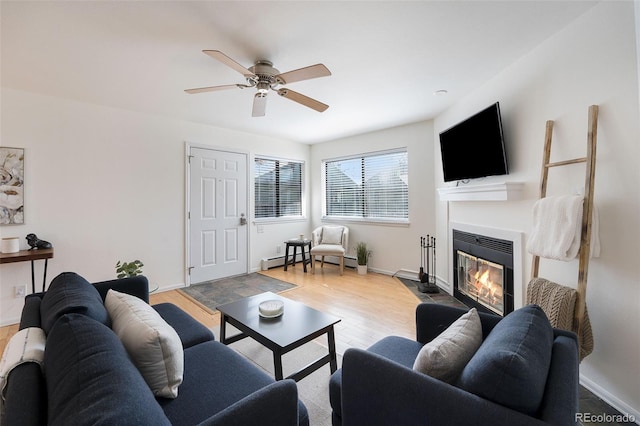 1830 22nd St Unit 16, Boulder, CO 80302 - living room featuring wood finished floors, a glass covered fireplace, a ceiling fan, and a baseboard heating unit