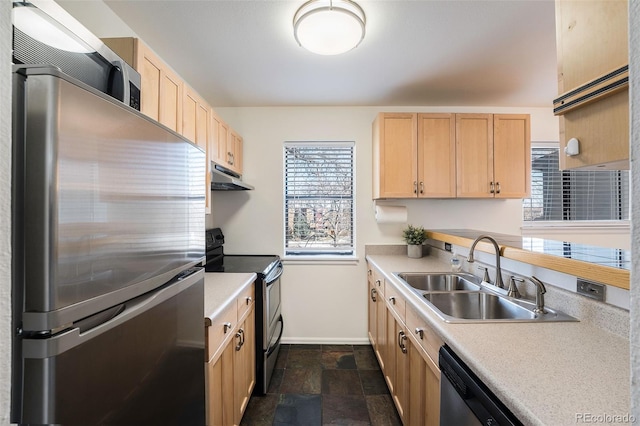 1830 22nd St Unit 16, Boulder, CO 80302 - kitchen featuring stainless steel appliances, under cabinet range hood, light brown cabinetry, light countertops, and dark stone finish floors