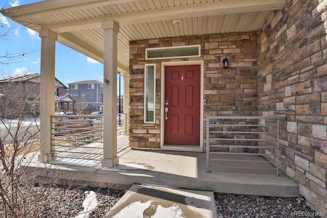 view of exterior entry with brick siding