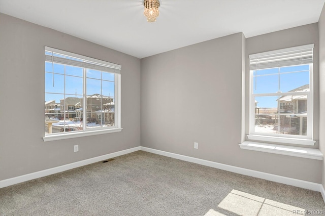 unfurnished room featuring visible vents, baseboards, and carpet flooring