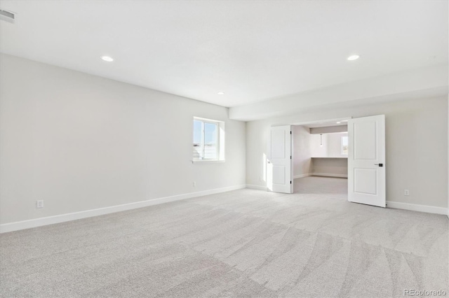 empty room featuring light carpet