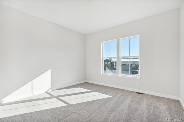 unfurnished room with light colored carpet