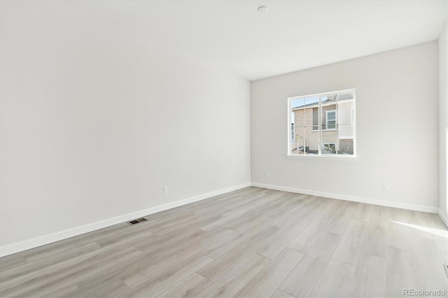 unfurnished room with light hardwood / wood-style floors