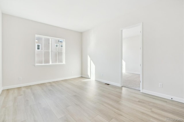 spare room featuring light hardwood / wood-style floors