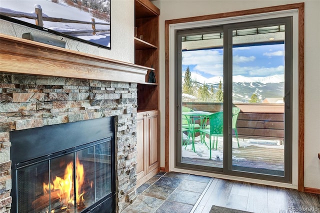 doorway featuring baseboards and a fireplace