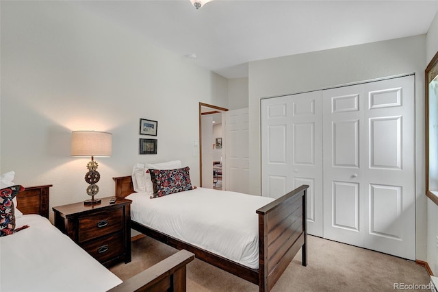 bedroom featuring light carpet and a closet