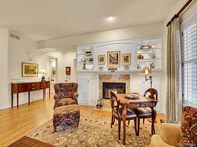 2571 Hunters Pl, Highlands Ranch, CO 80129 - living area with wood finished floors, a fireplace, and healthy amount of natural light